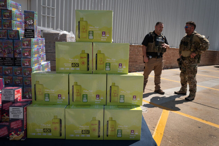 U.S. Marshals stand guard by vape products that were displayed outside Midwest Distribution after it was raided by federal agents